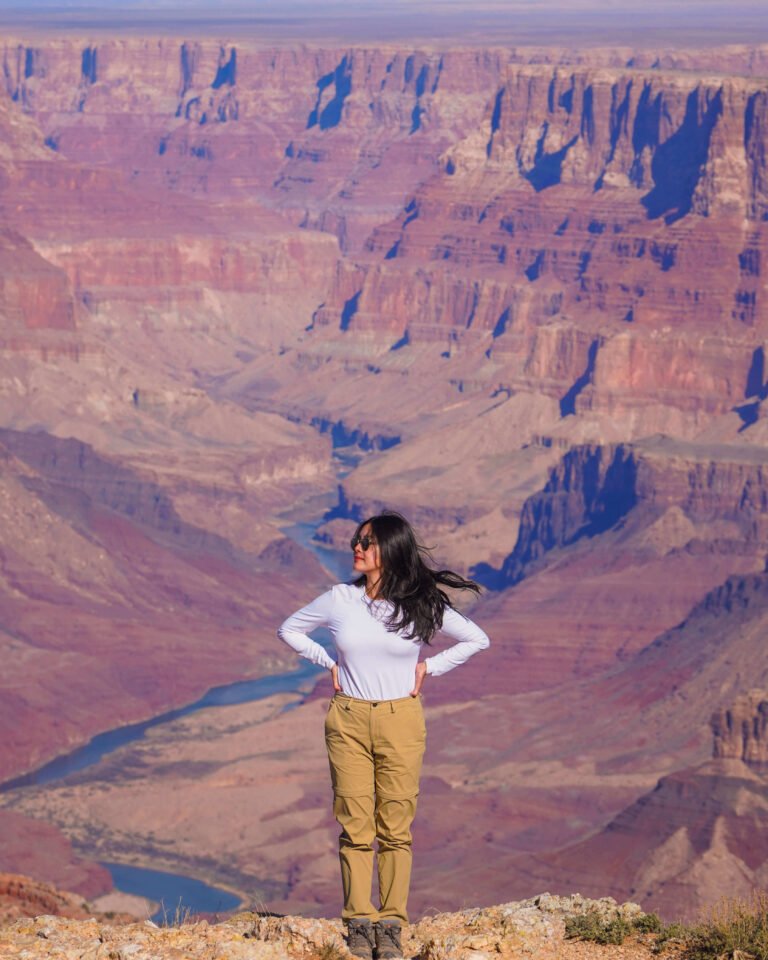 Lisa admiring the breathtaking panoramic views of the Grand Canyon from Navajo Viewpoint, with dramatic rock formations and deep canyon ridges stretching into the horizon