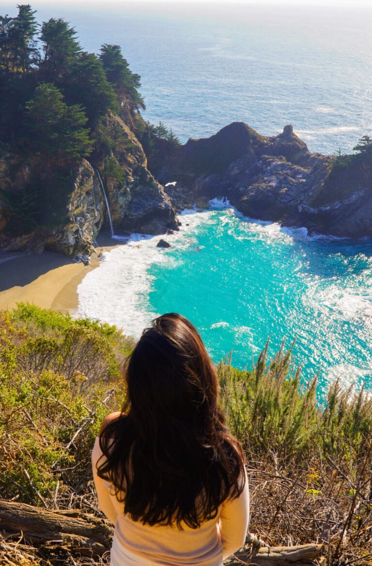 Breathtaking view of McWay Falls in Big Sur, California, cascading onto the beach, captured from a unique perspective