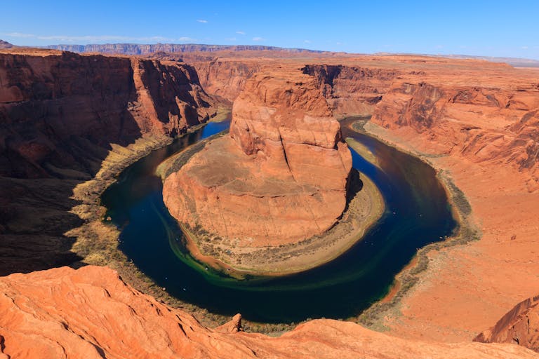 Breathtaking aerial shot of Horseshoe Bend, showcasing natural rock formations and the Colorado River in Arizona.