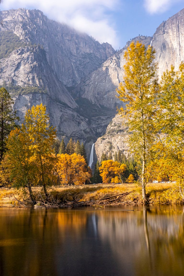 Breathtaking view of a waterfall in Yosemite National Park amidst vibrant autumn colors.